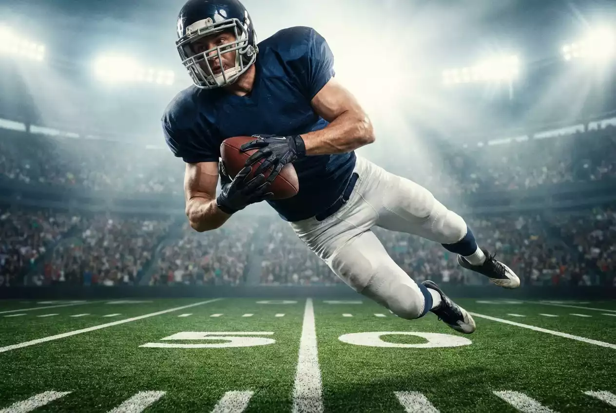 NFL Over/Under Wetten — Spieler beim Touchdown im vollen Stadion bei Flutlicht